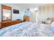 The bedroom features a wooden dresser, mounted television, and closet at 89 S Atlantic Ave # 1004, Ormond Beach, FL 32176