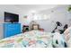 Bedroom featuring a television, blue dresser, and decor at 89 S Atlantic Ave # 1004, Ormond Beach, FL 32176