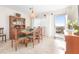 The dining room boasts neutral walls, a vintage hutch, and an open door to the balcony at 89 S Atlantic Ave # 1004, Ormond Beach, FL 32176