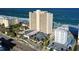 An exterior daytime view of a condo on the beach overlooking the ocean and parking lot from an elevated angle at 89 S Atlantic Ave # 1004, Ormond Beach, FL 32176