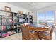 A game room with a poker table, chairs, bookshelves and access to an outdoor balcony at 89 S Atlantic Ave # 1004, Ormond Beach, FL 32176
