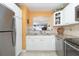 Bright kitchen features white cabinets, stainless steel appliances, granite countertops, and a pass-through to the living area at 89 S Atlantic Ave # 1004, Ormond Beach, FL 32176