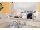 Granite countertops and a pass-through offer views of the ocean view from the kitchen into the living area at 89 S Atlantic Ave # 1004, Ormond Beach, FL 32176
