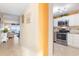 Bright kitchen features white cabinetry, stainless steel appliances, and a pass-through to the living area with ocean views at 89 S Atlantic Ave # 1004, Ormond Beach, FL 32176