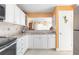 Kitchen with granite counters, white cabinets and a pass-through to the living area, complete with stainless appliances at 89 S Atlantic Ave # 1004, Ormond Beach, FL 32176