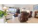 Living room with leather reclining chairs, a neutral couch and a large television overlooking an ocean view at 89 S Atlantic Ave # 1004, Ormond Beach, FL 32176