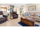 Charming living room featuring ocean themed decor, tile floors, and ample seating at 89 S Atlantic Ave # 1004, Ormond Beach, FL 32176