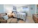 Comfortable main bedroom with calming colors, large window, and a relaxing sitting area at 89 S Atlantic Ave # 1004, Ormond Beach, FL 32176