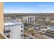 Balcony view showcasing the cityscape and lush greenery stretching towards the horizon under a clear blue sky at 89 S Atlantic Ave # 1004, Ormond Beach, FL 32176