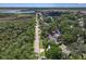 An aerial view of the property showing its location relative to the surrounding landscape and canal at 1108 Shockney Dr, Ormond Beach, FL 32174