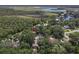 Beautiful aerial view of a home near a canal with lush tropical landscaping and mature trees at 1108 Shockney Dr, Ormond Beach, FL 32174