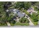 Stunning aerial view of a large home with lush landscaping, a pool, and water access at 1108 Shockney Dr, Ormond Beach, FL 32174