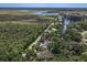 An aerial view of the property showing its location relative to the surrounding landscape and canal at 1108 Shockney Dr, Ormond Beach, FL 32174