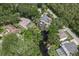 Aerial view of the property and neighborhood featuring mature trees and canal access at 1108 Shockney Dr, Ormond Beach, FL 32174