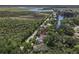 An aerial view of the property showing its location relative to the surrounding landscape and canal at 1108 Shockney Dr, Ormond Beach, FL 32174