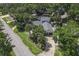 Aerial view of the property featuring lush landscaping and multi-car driveway at 1108 Shockney Dr, Ormond Beach, FL 32174