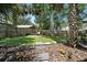 Serene backyard with stepping stones, lush greenery, and a wood fence providing a private outdoor space at 1108 Shockney Dr, Ormond Beach, FL 32174