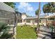 Backyard showcasing a stone façade, manicured lawn, stone planter, and a screened lanai at 1108 Shockney Dr, Ormond Beach, FL 32174