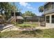 Backyard features lush landscaping, an elevated porch and screen enclosed pool providing ultimate outdoor relaxation at 1108 Shockney Dr, Ormond Beach, FL 32174