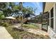 This backyard features lush landscaping, an elevated porch, and screen enclosed pool providing outdoor relaxation at 1108 Shockney Dr, Ormond Beach, FL 32174