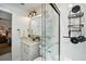 Well-lit bathroom showcasing a glass shower, neutral tiling, and vanity storage at 1108 Shockney Dr, Ormond Beach, FL 32174