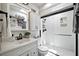 Bright bathroom featuring white cabinets, a skylight, and a glass-enclosed shower at 1108 Shockney Dr, Ormond Beach, FL 32174