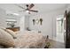 Comfortable bedroom with a ceiling fan, view of ensuite bathroom, and a decorative wreath at 1108 Shockney Dr, Ormond Beach, FL 32174