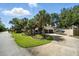 Charming home with a well-maintained lawn, palm trees, and a spacious driveway leading to a two-car garage at 1108 Shockney Dr, Ormond Beach, FL 32174