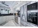 Updated kitchen boasts stainless steel appliances, white cabinetry, and sleek black marble countertops at 1108 Shockney Dr, Ormond Beach, FL 32174