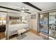 View of main bedroom showing hardwood floors, overhead fan, and sliding glass doors to the outside at 1108 Shockney Dr, Ormond Beach, FL 32174