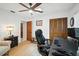 Well-lit office featuring a ceiling fan, storage closet, and light-colored hardwood floors at 1108 Shockney Dr, Ormond Beach, FL 32174