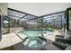 A screened-in pool and spa area offers a relaxing outdoor experience with comfortable seating at 1108 Shockney Dr, Ormond Beach, FL 32174