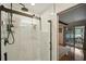 A relaxing walk-in shower with marble surround and bronze fixtures in the bathroom at 1108 Shockney Dr, Ormond Beach, FL 32174