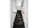 Carpeted staircase with white walls, offering an elegant and clean transition between floors at 1108 Shockney Dr, Ormond Beach, FL 32174
