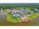 Exceptional aerial view of community amenities including pool, tennis courts, and lake access at 1254 Royal Pointe Ln, Ormond Beach, FL 32174