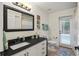 Bright bathroom featuring granite countertops, white cabinets, and access to the outdoors at 1254 Royal Pointe Ln, Ormond Beach, FL 32174
