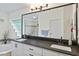 Bright bathroom features a double vanity, large mirror, corner tub, and glass block window at 1254 Royal Pointe Ln, Ormond Beach, FL 32174