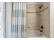 Well-lit tub and shower combination featuring decorative tile and modern fixtures at 1254 Royal Pointe Ln, Ormond Beach, FL 32174