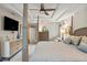 Well-lit bedroom showcasing a ceiling fan, large bed, and dresser at 1254 Royal Pointe Ln, Ormond Beach, FL 32174