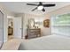 Serene bedroom featuring neutral decor, a dresser with a mirror, and plenty of natural light at 1254 Royal Pointe Ln, Ormond Beach, FL 32174
