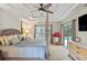 Spacious bedroom with a tray ceiling, ceiling fan, and a sliding glass door leads to a patio at 1254 Royal Pointe Ln, Ormond Beach, FL 32174