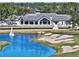 Picturesque view of the clubhouse at Plantation Bay, with a golf course and water feature in the foreground at 1254 Royal Pointe Ln, Ormond Beach, FL 32174
