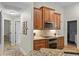 Kitchen featuring wooden cabinets, stainless steel microwave and oven, and granite countertops at 1254 Royal Pointe Ln, Ormond Beach, FL 32174