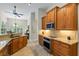 Open kitchen with stainless steel appliances and granite countertops at 1254 Royal Pointe Ln, Ormond Beach, FL 32174