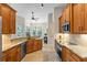 Warm wooden kitchen with granite countertops and stainless appliances at 1254 Royal Pointe Ln, Ormond Beach, FL 32174
