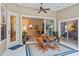 Inviting lanai with a dining table set, ceiling fan and views into the living room at 1254 Royal Pointe Ln, Ormond Beach, FL 32174