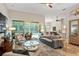 Living area with sliding glass doors leading to a screened-in patio and pool at 1254 Royal Pointe Ln, Ormond Beach, FL 32174