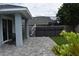 A cozy backyard featuring pavers, grass, and a relaxing hot tub area with fence at 146 Via Madrid Dr, Ormond Beach, FL 32176