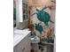 Nautical-themed bathroom features a turtle-patterned shower curtain and a coordinating toilet seat cover at 146 Via Madrid Dr, Ormond Beach, FL 32176