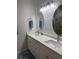 Bathroom featuring double sinks, white quartz counters, and decorative lighting at 146 Via Madrid Dr, Ormond Beach, FL 32176